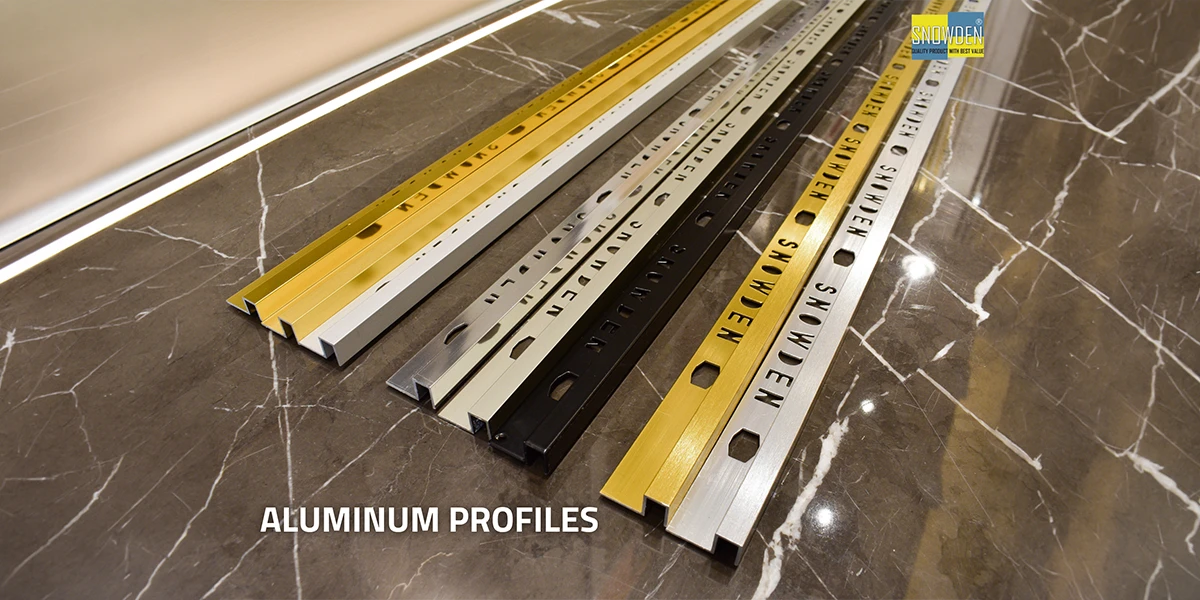 Aluminium profile manufacturer showcasing premium aluminium profiles in gold, silver, black and white finishes for tile edging, flooring and architectural installations.