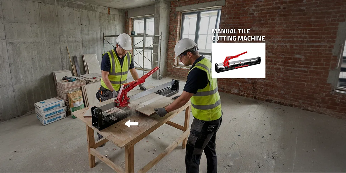 Worker using a heavy-duty manual tile cutting machine to score large ceramic tiles alongside a handheld tile breaking device.