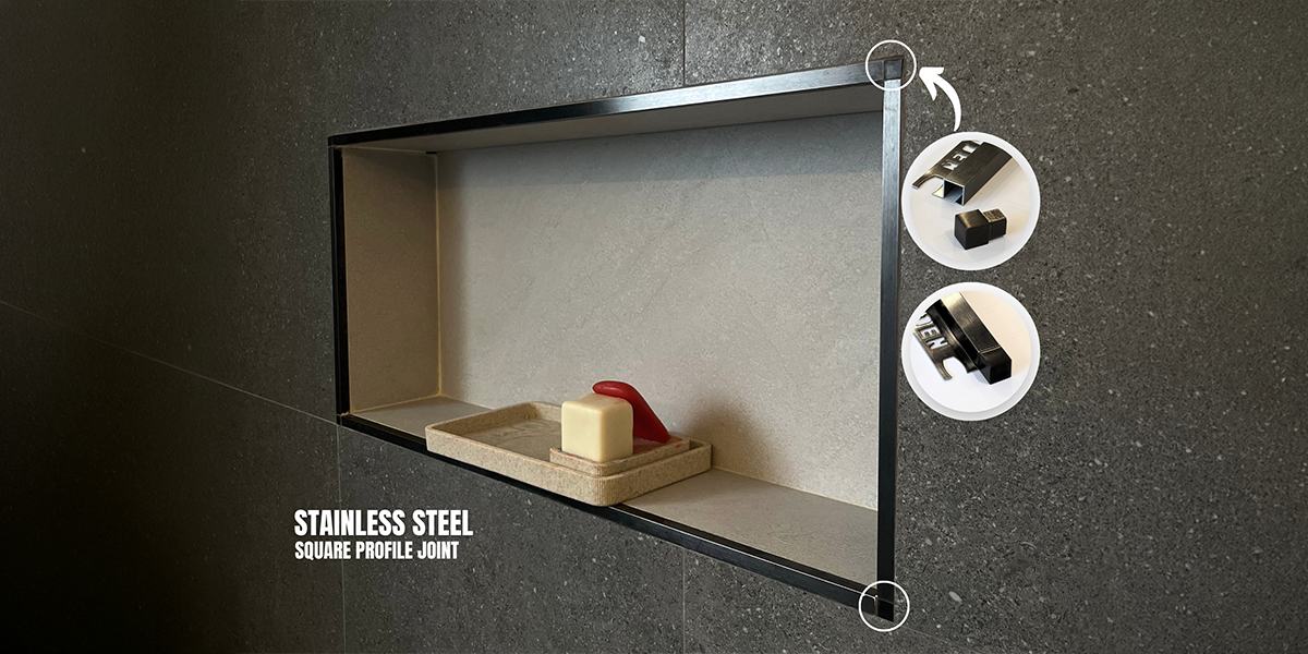Stainless Steel Profiles Manufacturer UAE - Black Square Profile Joint Black stainless steel square profile joint framing a dark tiled wall niche, crafted by a Stainless Steel Profiles Manufacturer UAE.