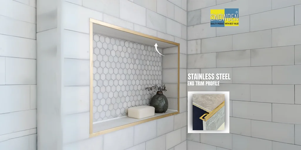 Gold end trim profile installed around a tiled bathroom shower niche, produced by a Stainless Steel Profiles Manufacturer UAE.